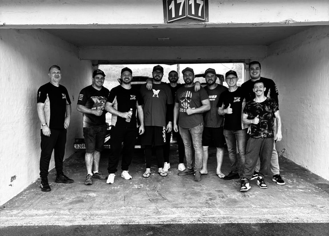 Grupo reunido na garagem com camisetas do clube